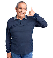 Wall Mural - senior handsome man wearing casual polo smiling doing phone gesture with hand and fingers like talki