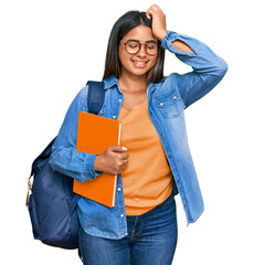 Poster - Young latin girl wearing student backpack and holding books smiling confident touching hair with hand up gesture, posing attractive and fashionable