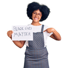 Wall Mural - Young african american girl holding black lives matter banner pointing finger to one self smiling happy and proud