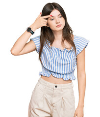 Poster - Young beautiful caucasian girl wearing casual clothes pointing unhappy to pimple on forehead, ugly infection of blackhead. acne and skin problem