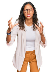 Poster - Young african american girl wearing business clothes shouting frustrated with rage, hands trying to strangle, yelling mad