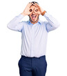 © Krakenimages.com - Young hispanic man wearing business clothes doing ok gesture like binoculars sticking tongue out, eyes looking through fingers. crazy expression.
