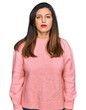 © Krakenimages.com - Beautiful hispanic woman wearing casual winter sweater with serious expression on face. simple and natural looking at the camera.