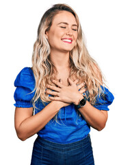 Sticker - Young blonde woman wearing casual clothes smiling with hands on chest with closed eyes and grateful gesture on face. health concept.