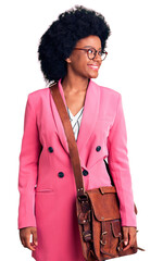 Poster - Young african american woman wearing business clothes and leather bag looking away to side with smile on face, natural expression. laughing confident.