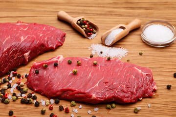 	
Raw piece of meat steak with rosemary on wooden table	
