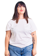 Poster - Young plus size woman wearing casual clothes smiling looking to the side and staring away thinking.