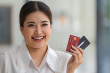Asian Businesswoman Smiling With Credit Cards.