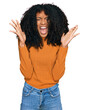 © Krakenimages.com - Young african american girl wearing casual clothes celebrating mad and crazy for success with arms raised and closed eyes screaming excited. winner concept