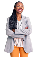 Wall Mural - Young african american woman wearing business clothes happy face smiling with crossed arms looking at the camera. positive person.