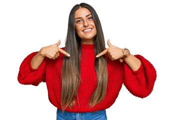 Canvas Print - Beautiful hispanic woman wearing casual clothes looking confident with smile on face, pointing oneself with fingers proud and happy.