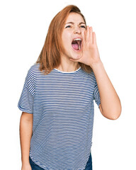 Wall Mural - Young caucasian woman wearing casual clothes shouting and screaming loud to side with hand on mouth. communication concept.