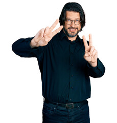 Poster - Middle age caucasian man wearing casual clothes and glasses smiling looking to the camera showing fingers doing victory sign. number two.