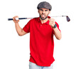 © Krakenimages.com - Young handsome man with beard playing golf holding club and ball annoyed and frustrated shouting with anger, yelling crazy with anger and hand raised