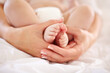 Woman, child and feet closeup for love connection or childhood bonding, motherhood or newborn. Female person, infant and toes or care support for kid growth development, parent trust or nurture youth