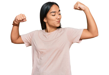 Poster - Young asian woman wearing casual clothes showing arms muscles smiling proud. fitness concept.