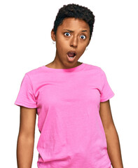 Wall Mural - Young african american woman wearing casual clothes in shock face, looking skeptical and sarcastic, surprised with open mouth