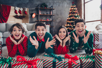 Poster - Full length portrait of astonished cheerful buddies lying carpet floor open mouth receive desirable new year giftbox house indoors