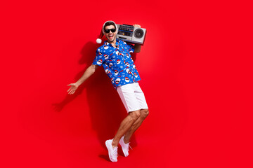 Sticker - Full length photo of nice young male dance boom box tiptoes dressed santa claus print x-mas garment isolated on red color background