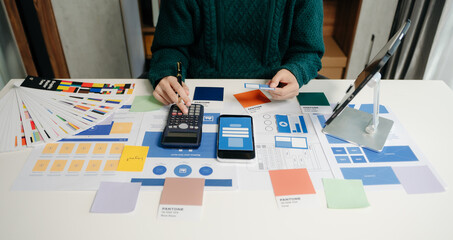 Wall Mural - view of ui developer team brainstorming on their project with laptop, smartphone and digital tablet.