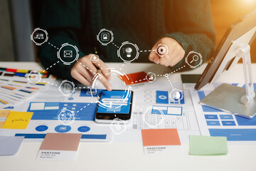 Wall Mural - view of ui developer team brainstorming on their project with laptop, smartphone and digital tablet.