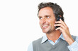 © STEEX/peopleimages.com - Smile, phone call and mature businessman in studio for corporate communication or discussion. Happy, technology and professional male person on mobile conversation with cellphone by white background.