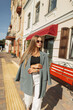 © alones - Beautiful urban fashion woman with sunglasses in stylish clothes walks on a sunny day in the city