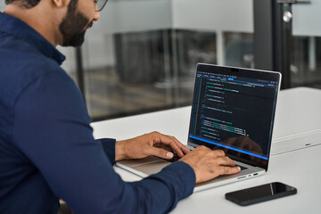 busy indian business man software developer engineer working on laptop computer in office. male admi