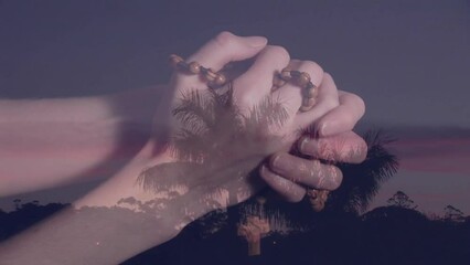 Wall Mural - Animation of landscape over caucasian woman's hands with rosary