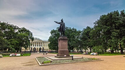 Canvas Print - Alexander Pushkin Monument on Arts Square, Russian Museum (Mikhailovsky Palace) backdrop, captured in timelapse hyperlapse. St. Petersburg, Russia