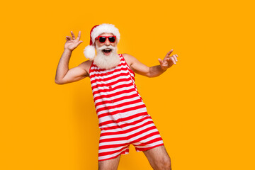 Poster - Photo of cheerful good mood elderly guy wear new year swimsuit hat sunglass dancing disco empty space isolated yellow color background