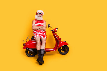 Poster - Full length photo of funky confident senior guy christmas swimwear hat riding moped delivering gifts empty space isolated yellow color background