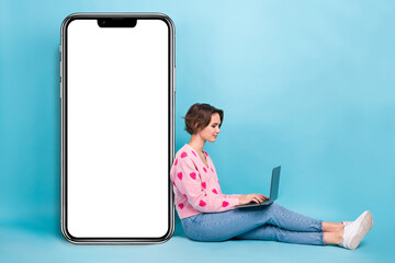 Full size body photo of satisfied young it specialist student girl first program create website for phone isolated on blue color background