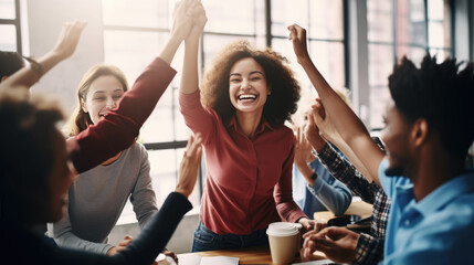 Group of professionals in an office setting, celebrating a success with raised arms and joyful expressions, indicating a sense of teamwork and achievement.