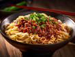 Spicy Sichuan-style noodles with minced pork on wooden table