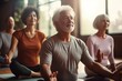 © urdialex - elder people practicing yoga in group in a yoga class