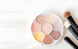 © Oleksiy - colorful makeup eyeshadow with shimmer on white wooden table soft light for beauty card decor