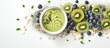 Superfood smoothie bowl with matcha green tea chia flax and pumpkin seeds bee pollen granola coconut flakes kiwi and blueberries displayed from above Copy space image Place for adding text or d
