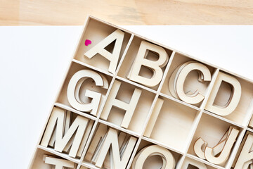 Sticker - wooden letters in a box with many square compartments on paper and wood (includes a tiny heart)