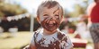 Joyful Child with Chocolate on Face and Hands