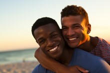 Homosexual Gay Couple Embracing On Beach At Sunset. Men Hugging Each Other  With Tender. The Couple At Honeymoon In Vacation Near The Ocean. LGBT Concept
