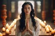 A Chinese woman engages in prayer and meditation in a temple, seeking the serenity that brings inner peace and mental well-being