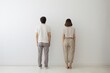 © Konstiantyn Zap - A woman and a man, both facing away, share a moment of connection against a plain white backdrop, suggesting mutual understanding
