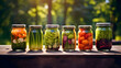 Set of glass jars or pots full of fresh organic and colorful vegetables from agricultural labor, placed on a wooden table in nature, on a sunny day.  Pickled healthy vegetarian food, homemade products