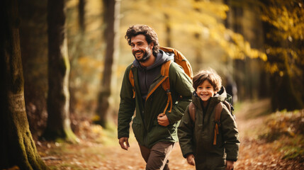 smiling son and father walking with backpacks through the forest, nature reserve, hiking, tall trees, blurred background, man, boy, trail, tourists, travel, hike, family, weekend together, child, kid