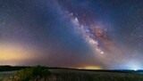 Fototapeta Tęcza - milky way galaxy on a night sky long exposure photograph with