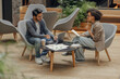 © Yaroslav Astakhov - Two business colleagues working together on project while using laptop in modern coworking