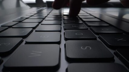 Wall Mural - a program coder is typing on laptop keyboard close up macro. hacker is using computer. man hands are