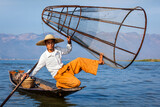 Fototapeta Sypialnia - Myanmar travel attraction landmark - Traditional Burmese fisherman with fishing net at Inle lake in Myanmar famous for their distinctive one legged rowing style