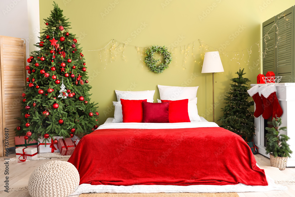 Interior of bedroom with Christmas trees and fireplace